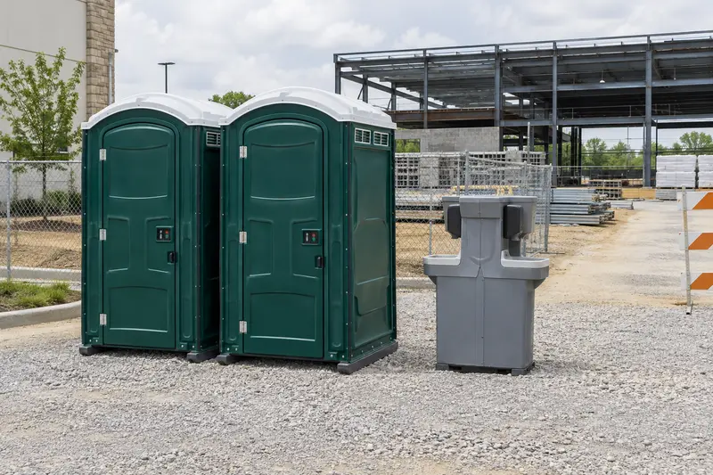 Portable restroom cabins at an illustrative construction site